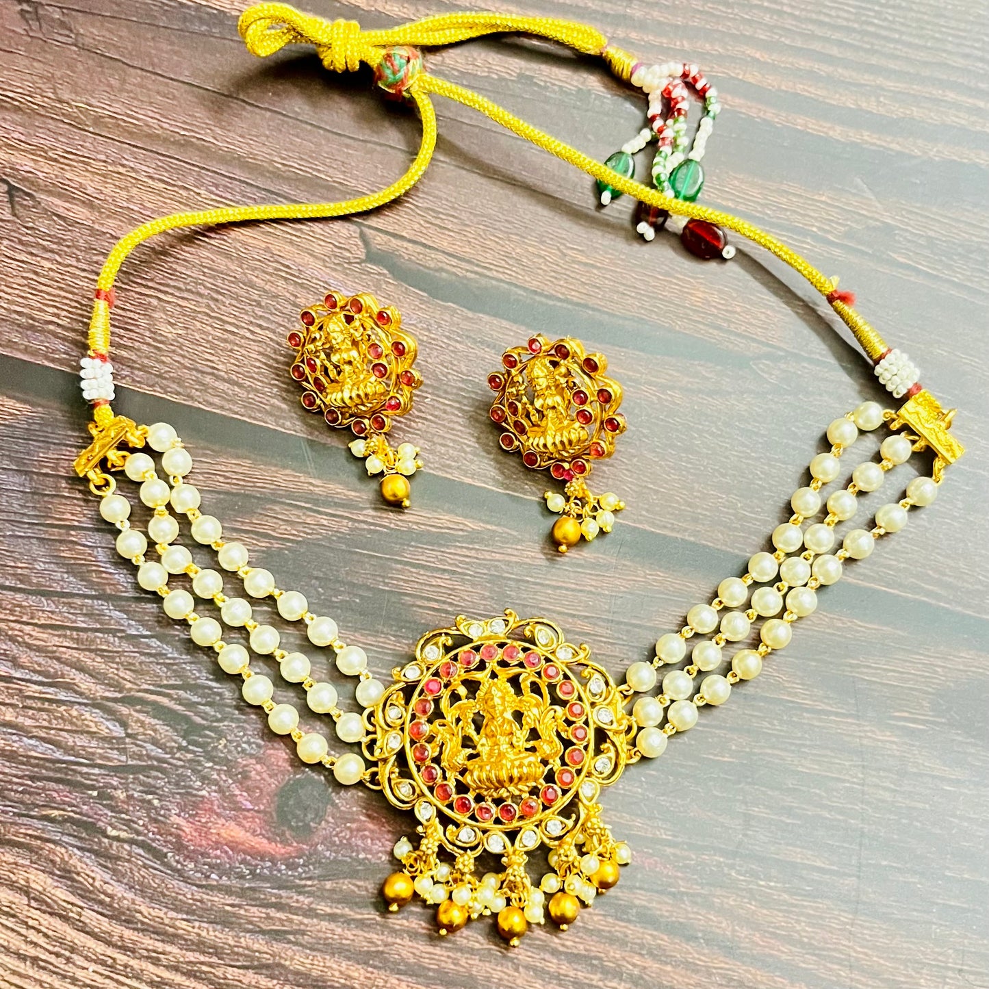 lakshmi choker, temple jewelry, pearl choker, traditional jewelry, Indian jewelry, south Indian style, bridal choker set, handcrafted jewelry, gold plated, festive wear, ethnic accessories, wedding jewelry, goddess jewelry, kundan stones, handmade necklace, antique finish, cultural jewelry, jewelry set with earrings, pooja jewelry, divine design, Indian bride, pearl necklace set, goddess lakshmi, matsya boutique, statement choker