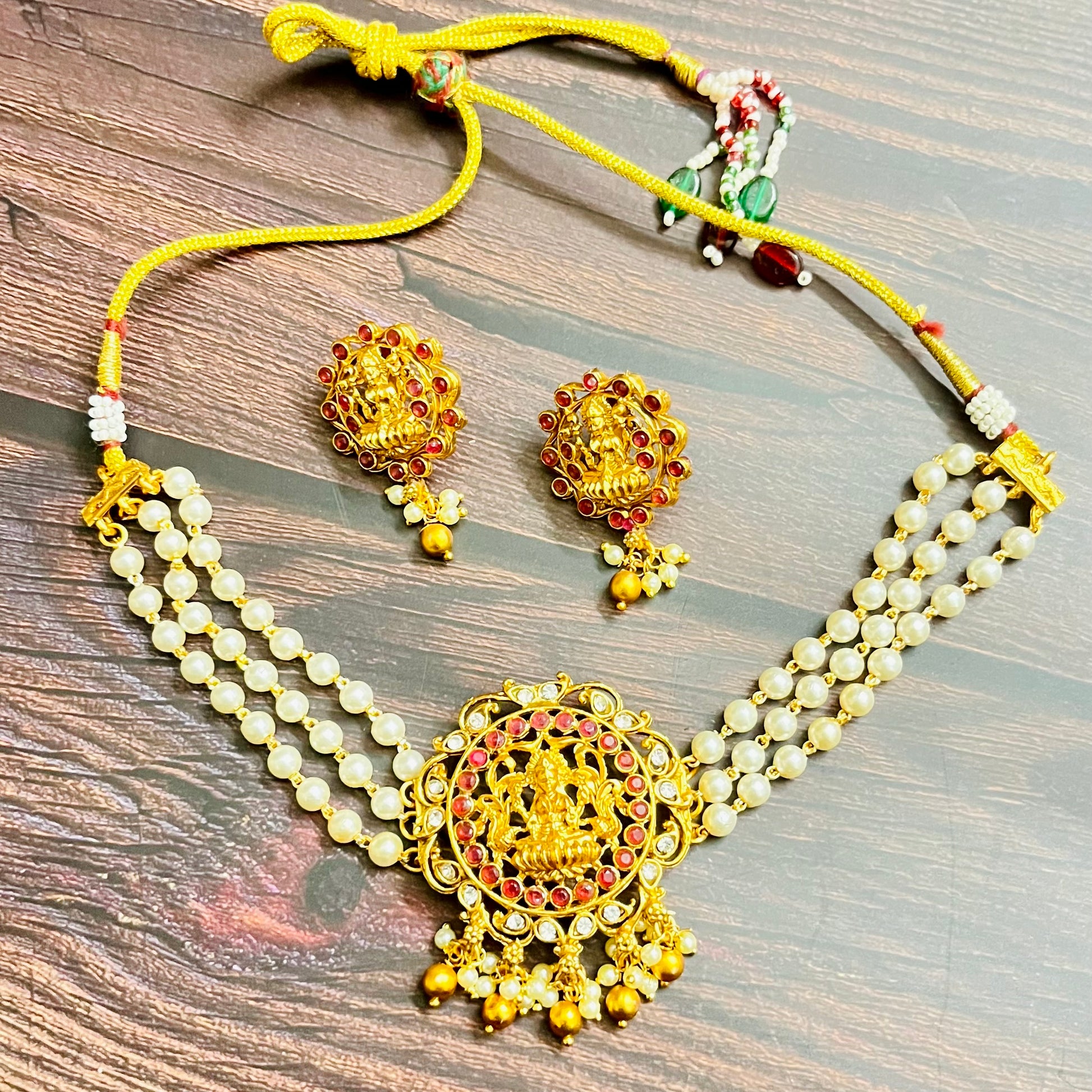 lakshmi choker, temple jewelry, pearl choker, traditional jewelry, Indian jewelry, south Indian style, bridal choker set, handcrafted jewelry, gold plated, festive wear, ethnic accessories, wedding jewelry, goddess jewelry, kundan stones, handmade necklace, antique finish, cultural jewelry, jewelry set with earrings, pooja jewelry, divine design, Indian bride, pearl necklace set, goddess lakshmi, matsya boutique, statement choker