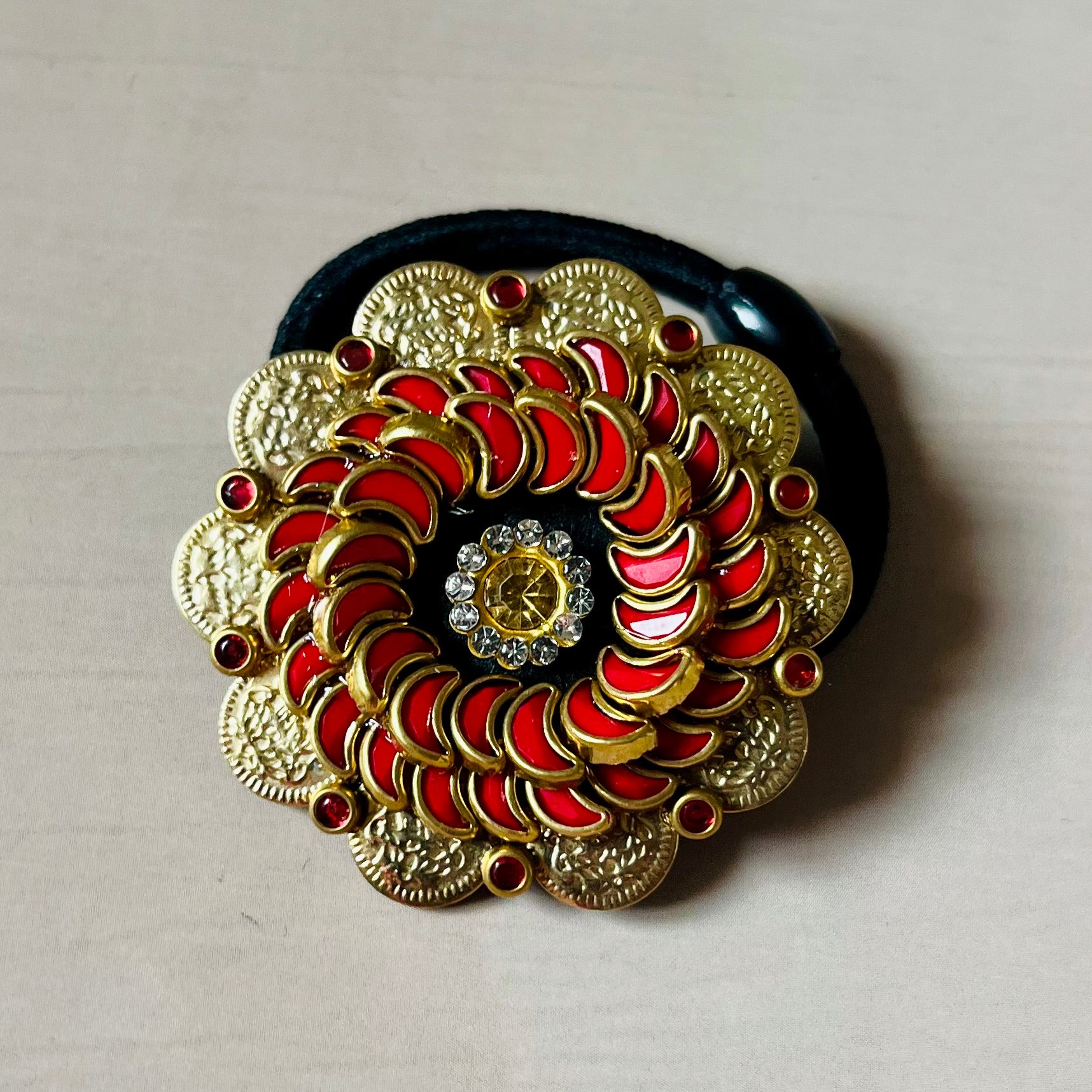 Surya Kalika hair accessory, juda pin, traditional hair accessory, bridal hair brooch, red gold hair clip, bun pin for saree, ethnic hair ornament, Indian hair accessory, juda hair brooch, wedding hair pin, kundan style hair pin, temple jewelry accessory, South Indian hair clip, festive hair accessory, handmade hair brooch, floral bun pin, juda accessory for women, ethnic hair clip, hair accessory for lehenga, designer juda pin