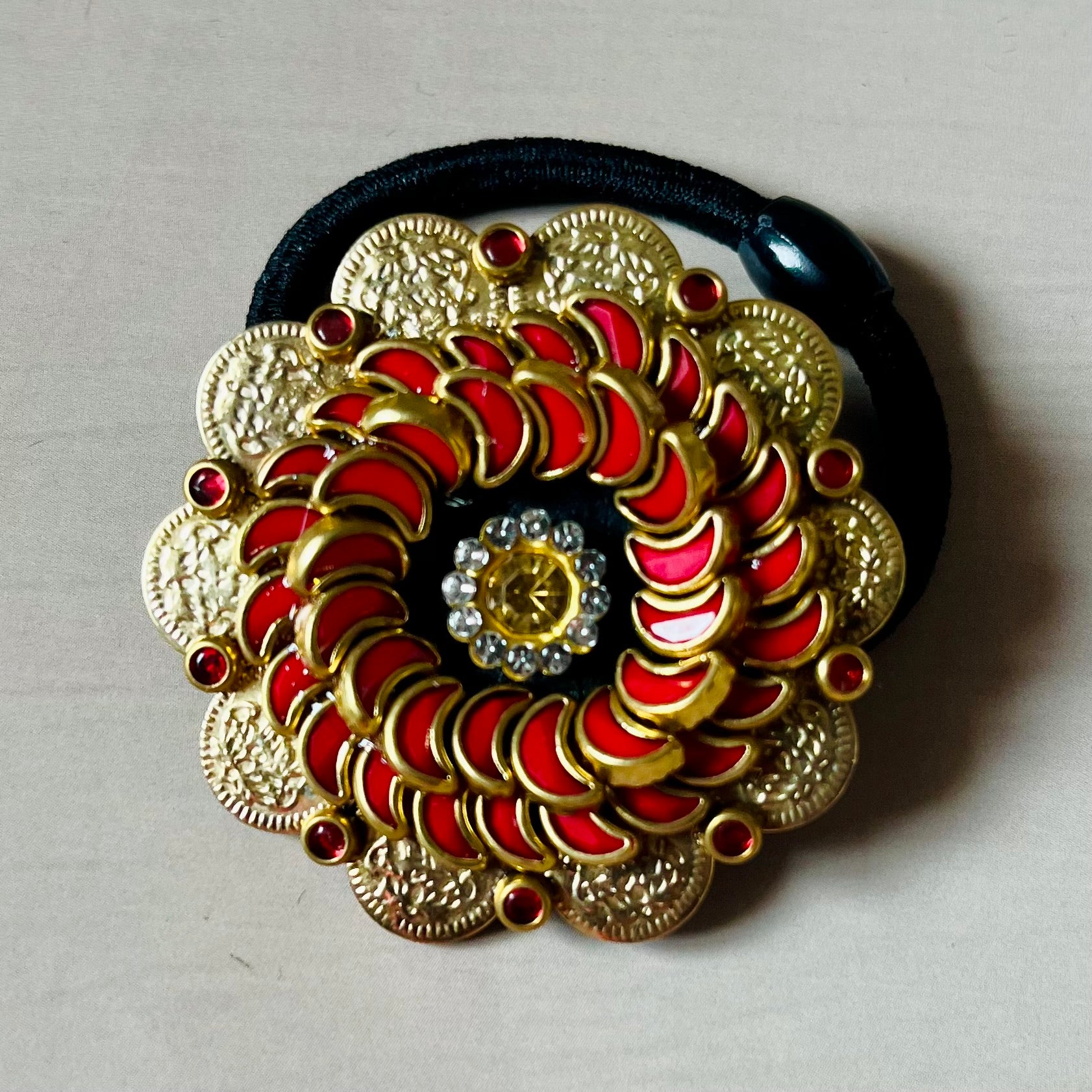 Surya Kalika hair accessory, juda pin, traditional hair accessory, bridal hair brooch, red gold hair clip, bun pin for saree, ethnic hair ornament, Indian hair accessory, juda hair brooch, wedding hair pin, kundan style hair pin, temple jewelry accessory, South Indian hair clip, festive hair accessory, handmade hair brooch, floral bun pin, juda accessory for women, ethnic hair clip, hair accessory for lehenga, designer juda pin