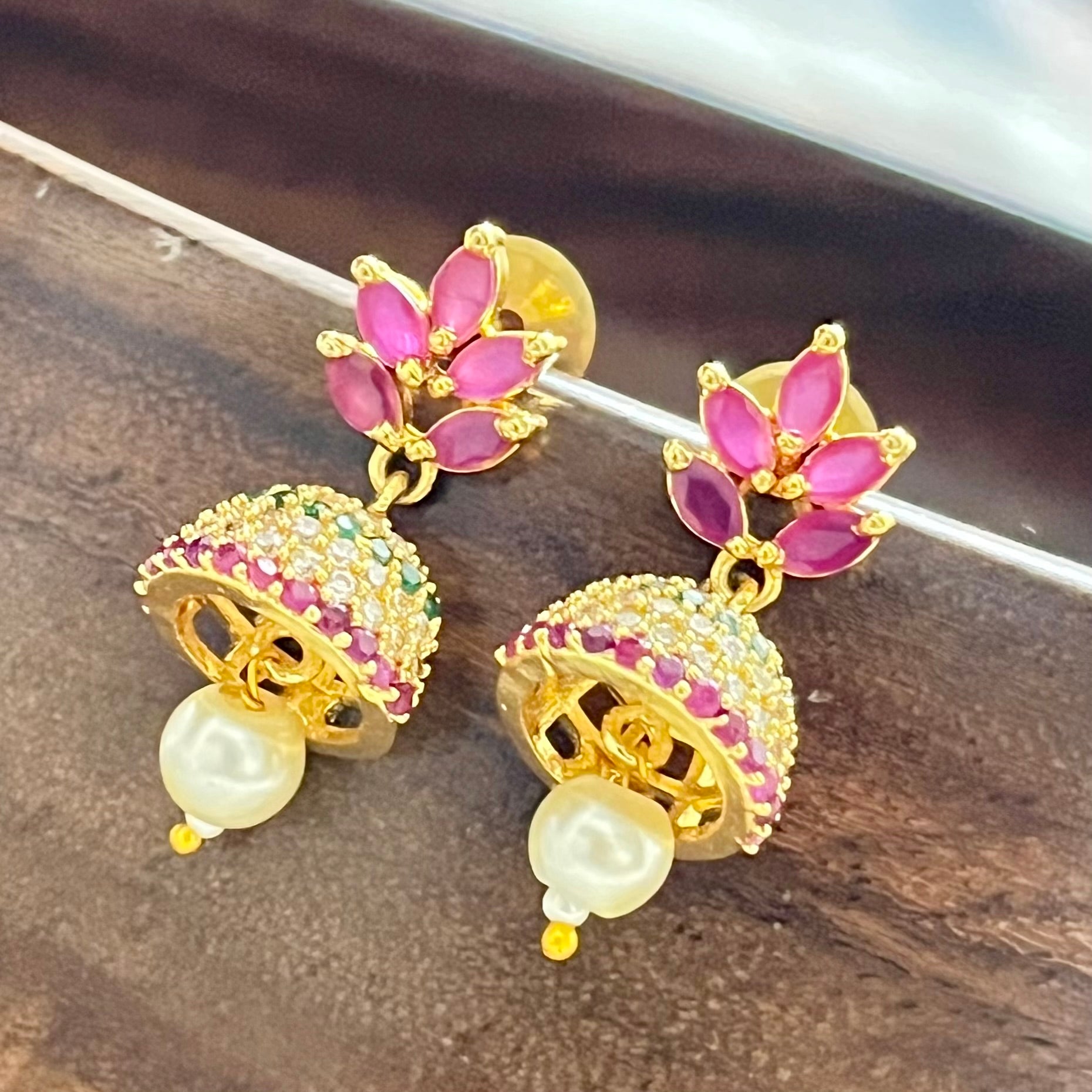 Traditional jewelry, South Indian jewelry, ruby jhumka, handcrafted earrings, Indian festive jewelry, wedding jewelry, Kanjeevaram saree accessories, silk lehenga jewelry, pearl jhumka, ethnic earrings, handmade jewelry India, bridal earrings, classical dance jewelry, festive accessories, gold tone jewelry, floral jhumka, lightweight earrings, Indian heritage jewelry, ethnic fashion accessories, royal jewelry, Indian traditional earrings, statement jhumkas, Indian ethnic wear, festival jewelry, Matsya Bouti