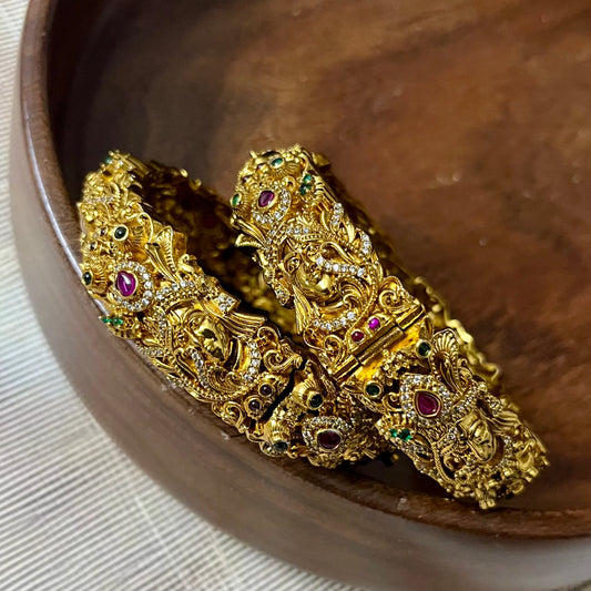 Sri Krishna bangles, Mayura bangles, Krishna peacock bangles, Antique gold bangles, Temple jewelry bangles, Handcrafted kada bangles, Ruby emerald bangles, Traditional Indian bridal jewelry, Spiritual jewelry for weddings, Festive occasion bangles, Indian ethnic bangles, Lord Krishna jewelry, Temple style bangles, Peacock motif jewelry, Hand-set stones bangles, Bridal bangles online India