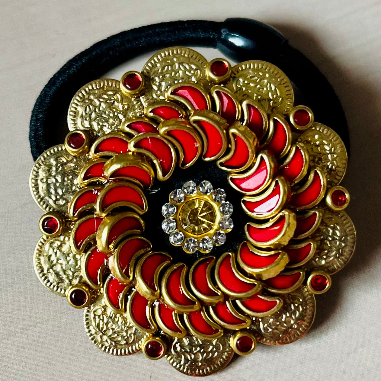 Surya Kalika hair accessory, juda pin, traditional hair accessory, bridal hair brooch, red gold hair clip, bun pin for saree, ethnic hair ornament, Indian hair accessory, juda hair brooch, wedding hair pin, kundan style hair pin, temple jewelry accessory, South Indian hair clip, festive hair accessory, handmade hair brooch, floral bun pin, juda accessory for women, ethnic hair clip, hair accessory for lehenga, designer juda pin