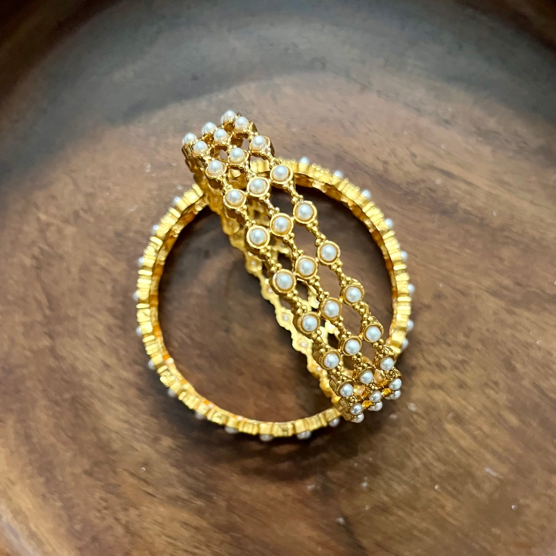 pearl mesh bangles, gold tone bangles, bridal bangles set, traditional kada bangles, pearl kada for women, ethnic bangle set, Indian wedding bangles, festive wear bangles, gold pearl kada, handcrafted bangles, royal pearl bangles, mesh design bangles, kundan style bangles, designer bangles online, party wear bangles for saree