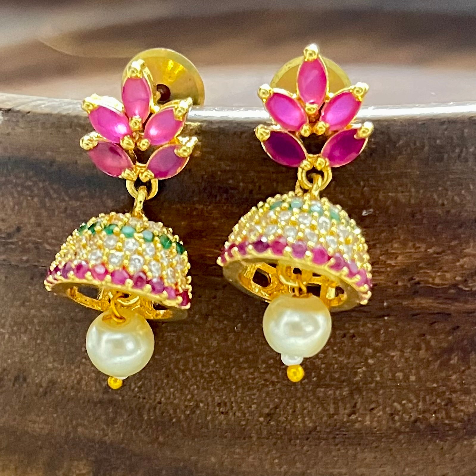 Traditional jewelry, South Indian jewelry, ruby jhumka, handcrafted earrings, Indian festive jewelry, wedding jewelry, Kanjeevaram saree accessories, silk lehenga jewelry, pearl jhumka, ethnic earrings, handmade jewelry India, bridal earrings, classical dance jewelry, festive accessories, gold tone jewelry, floral jhumka, lightweight earrings, Indian heritage jewelry, ethnic fashion accessories, royal jewelry, Indian traditional earrings, statement jhumkas, Indian ethnic wear, festival jewelry, Matsya Bouti