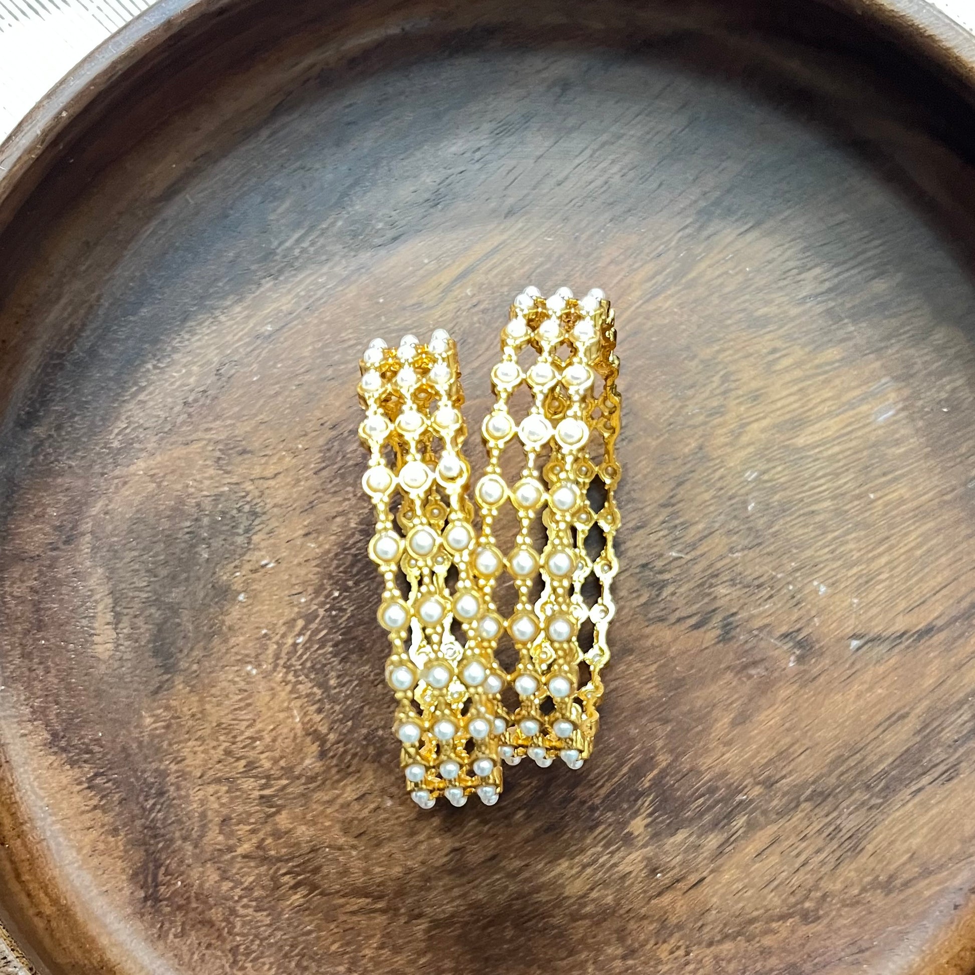 pearl mesh bangles, gold tone bangles, bridal bangles set, traditional kada bangles, pearl kada for women, ethnic bangle set, Indian wedding bangles, festive wear bangles, gold pearl kada, handcrafted bangles, royal pearl bangles, mesh design bangles, kundan style bangles, designer bangles online, party wear bangles for saree