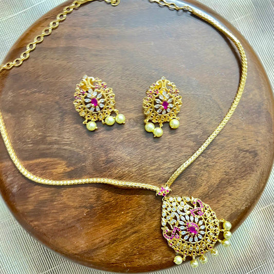 gold-plated jewelry set, necklace and earring set, traditional Indian jewelry, ruby stone necklace, pearl drop earrings, bridal jewelry set, ethnic jewelry, wedding jewelry, festive jewelry, antique finish necklace, Indian necklace set, kundan style jewelry, temple jewelry set, handcrafted jewelry, party wear necklace, designer jewelry set, red and gold jewelry, floral design necklace, imitation jewelry set, ethnic wear accessories