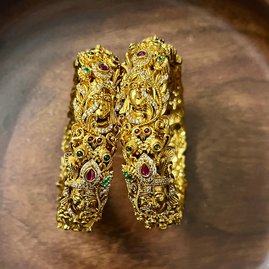 Sri Krishna bangles, Mayura bangles, Krishna peacock bangles, Antique gold bangles, Temple jewelry bangles, Handcrafted kada bangles, Ruby emerald bangles, Traditional Indian bridal jewelry, Spiritual jewelry for weddings, Festive occasion bangles, Indian ethnic bangles, Lord Krishna jewelry, Temple style bangles, Peacock motif jewelry, Hand-set stones bangles, Bridal bangles online India