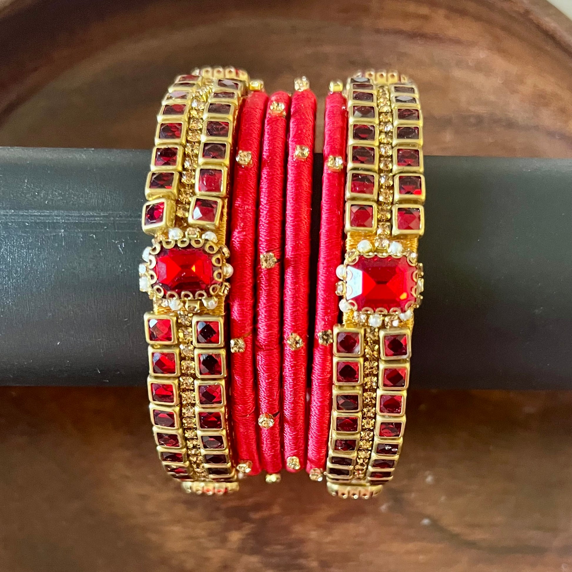 red silk thread bangles, kundan bangles, bridal bangles, wedding bangles, red bangles set, handmade bangles, traditional bangles, festive bangles, Indian bangles, ethnic bangles, red and gold bangles, kundan stone bangles, silk thread jewelry, desi bangles, bangle set for women, party wear bangles, navratri bangles, mehndi bangles, Indian bridal accessories, royal red bangles