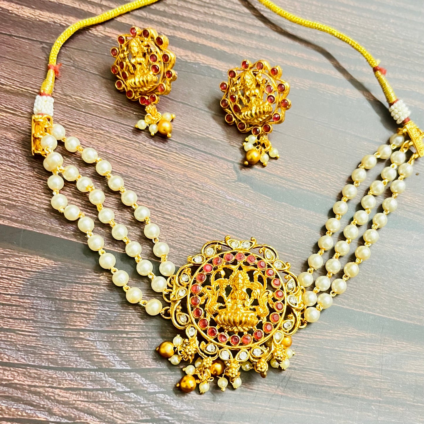 lakshmi choker, temple jewelry, pearl choker, traditional jewelry, Indian jewelry, south Indian style, bridal choker set, handcrafted jewelry, gold plated, festive wear, ethnic accessories, wedding jewelry, goddess jewelry, kundan stones, handmade necklace, antique finish, cultural jewelry, jewelry set with earrings, pooja jewelry, divine design, Indian bride, pearl necklace set, goddess lakshmi, matsya boutique, statement choker