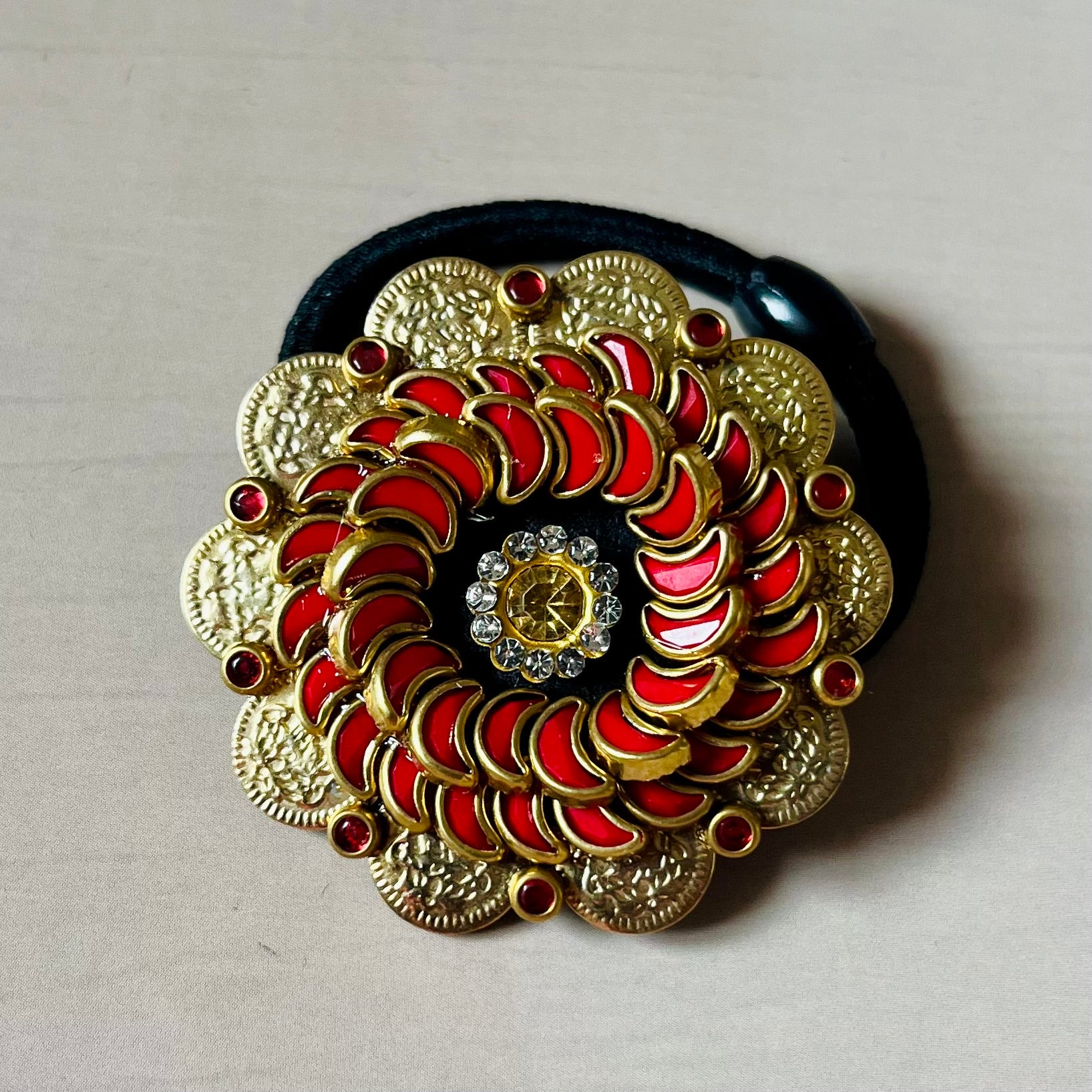 Surya Kalika hair accessory, juda pin, traditional hair accessory, bridal hair brooch, red gold hair clip, bun pin for saree, ethnic hair ornament, Indian hair accessory, juda hair brooch, wedding hair pin, kundan style hair pin, temple jewelry accessory, South Indian hair clip, festive hair accessory, handmade hair brooch, floral bun pin, juda accessory for women, ethnic hair clip, hair accessory for lehenga, designer juda pin