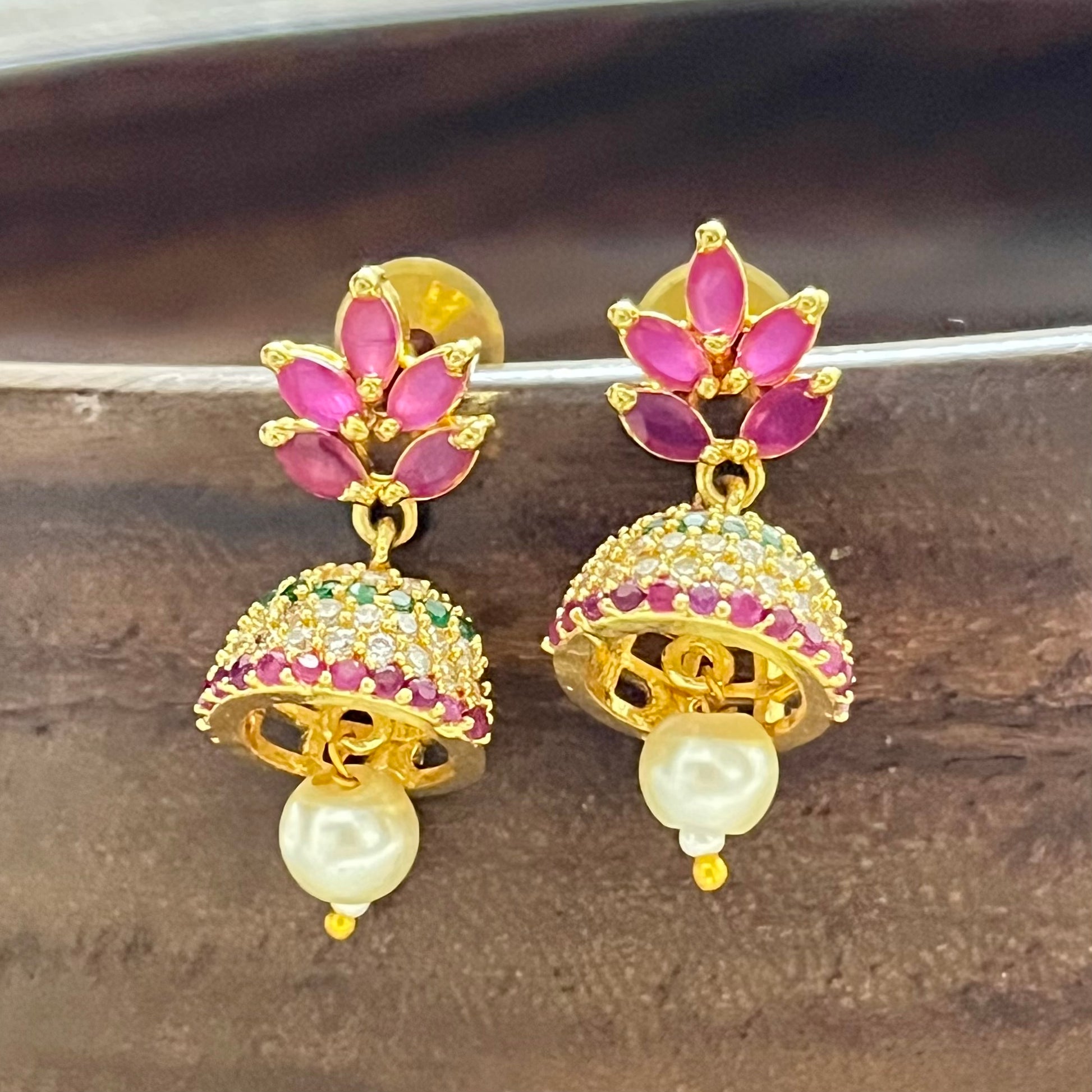Traditional jewelry, South Indian jewelry, ruby jhumka, handcrafted earrings, Indian festive jewelry, wedding jewelry, Kanjeevaram saree accessories, silk lehenga jewelry, pearl jhumka, ethnic earrings, handmade jewelry India, bridal earrings, classical dance jewelry, festive accessories, gold tone jewelry, floral jhumka, lightweight earrings, Indian heritage jewelry, ethnic fashion accessories, royal jewelry, Indian traditional earrings, statement jhumkas, Indian ethnic wear, festival jewelry, Matsya Bouti
