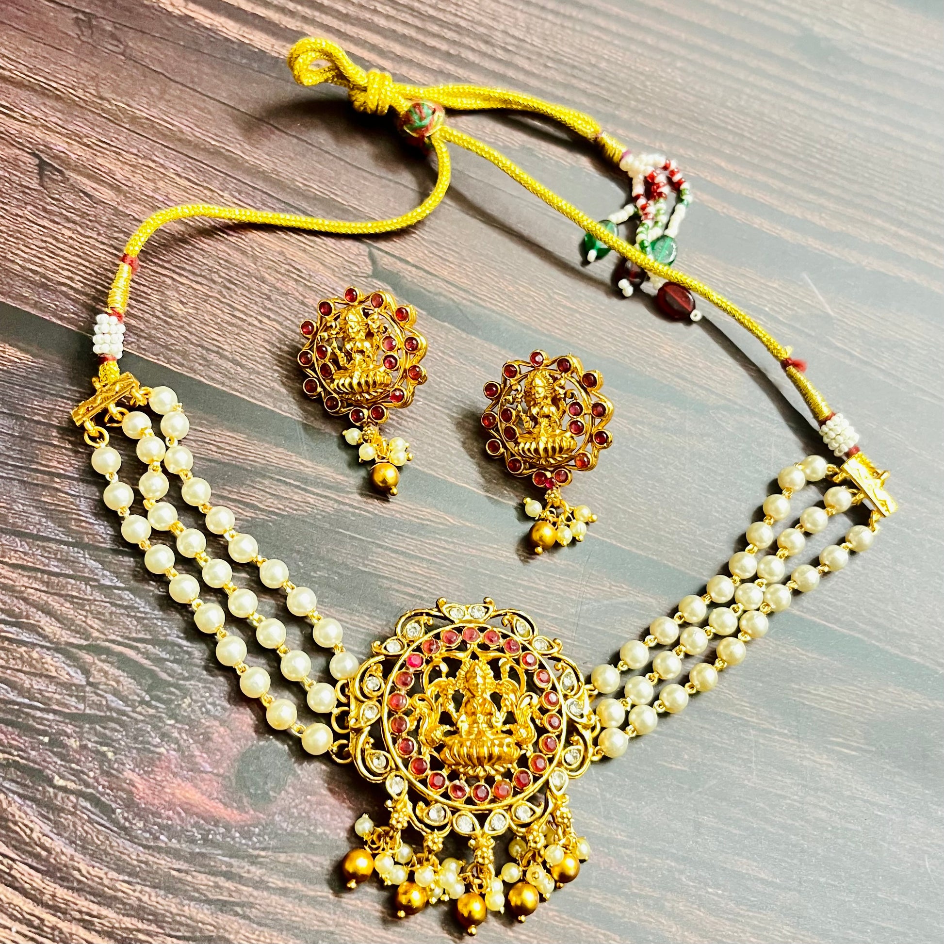 lakshmi choker, temple jewelry, pearl choker, traditional jewelry, Indian jewelry, south Indian style, bridal choker set, handcrafted jewelry, gold plated, festive wear, ethnic accessories, wedding jewelry, goddess jewelry, kundan stones, handmade necklace, antique finish, cultural jewelry, jewelry set with earrings, pooja jewelry, divine design, Indian bride, pearl necklace set, goddess lakshmi, matsya boutique, statement choker