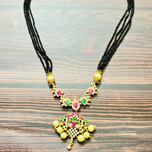 mangalsutra, bridal mangalsutra, pearl jewelry, traditional jewelry, gold plated, black beads necklace, Indian wedding, gemstone jewelry, emerald necklace, ruby necklace, designer mangalsutra, ethnic jewelry, south Indian jewelry, bridal accessories, handmade jewelry, temple jewelry, marriage mangalsutra, gold jewelry, multi-strand mangalsutra, heritage jewelry, festive jewelry, Indian bride, statement necklace, antique style, classic mangalsutra