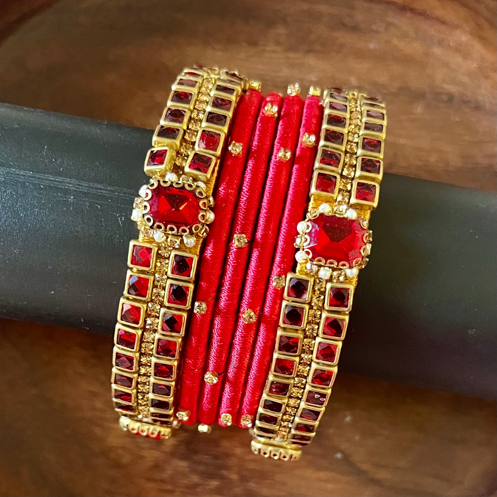 red silk thread bangles, kundan bangles, bridal bangles, wedding bangles, red bangles set, handmade bangles, traditional bangles, festive bangles, Indian bangles, ethnic bangles, red and gold bangles, kundan stone bangles, silk thread jewelry, desi bangles, bangle set for women, party wear bangles, navratri bangles, mehndi bangles, Indian bridal accessories, royal red bangles