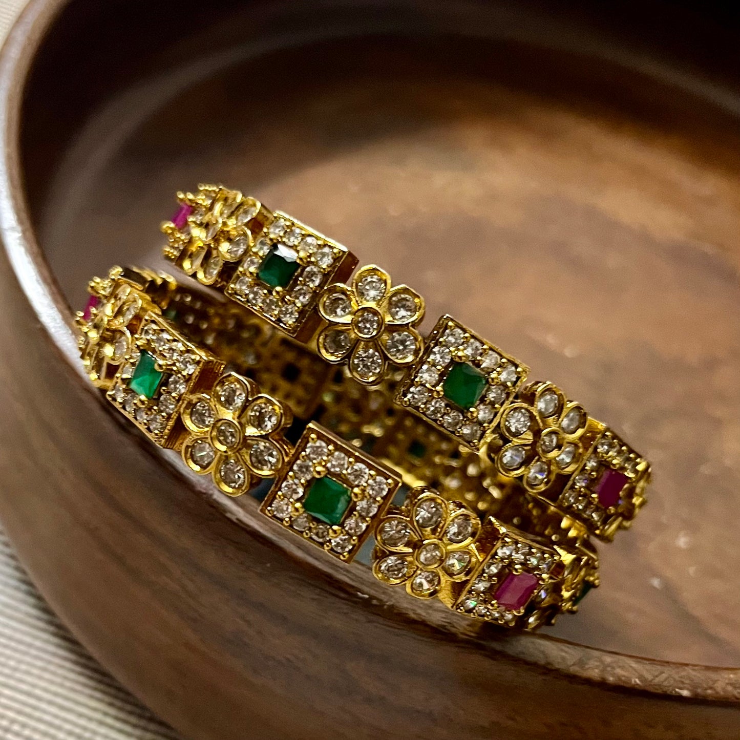 antique gold bangles, floral design bangles, emerald ruby bangles, kundan stone bangles, wedding bangle set, traditional kada bangles, bridal bangles online, festive wear jewelry, stone studded bangles, ethnic jewelry for women, handcrafted Indian bangles, designer bangles for saree, party wear bangles, temple style bangles, royal look bangles