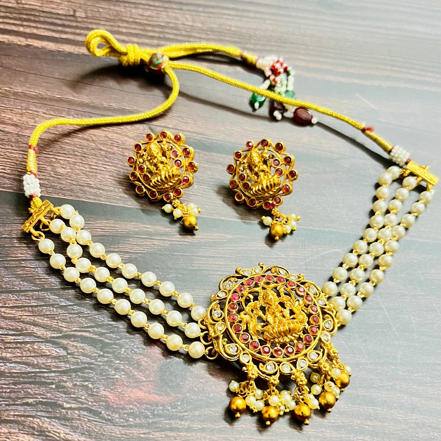lakshmi choker, temple jewelry, pearl choker, traditional jewelry, Indian jewelry, south Indian style, bridal choker set, handcrafted jewelry, gold plated, festive wear, ethnic accessories, wedding jewelry, goddess jewelry, kundan stones, handmade necklace, antique finish, cultural jewelry, jewelry set with earrings, pooja jewelry, divine design, Indian bride, pearl necklace set, goddess lakshmi, matsya boutique, statement choker