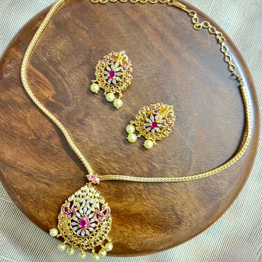 gold-plated jewelry set, necklace and earring set, traditional Indian jewelry, ruby stone necklace, pearl drop earrings, bridal jewelry set, ethnic jewelry, wedding jewelry, festive jewelry, antique finish necklace, Indian necklace set, kundan style jewelry, temple jewelry set, handcrafted jewelry, party wear necklace, designer jewelry set, red and gold jewelry, floral design necklace, imitation jewelry set, ethnic wear accessories