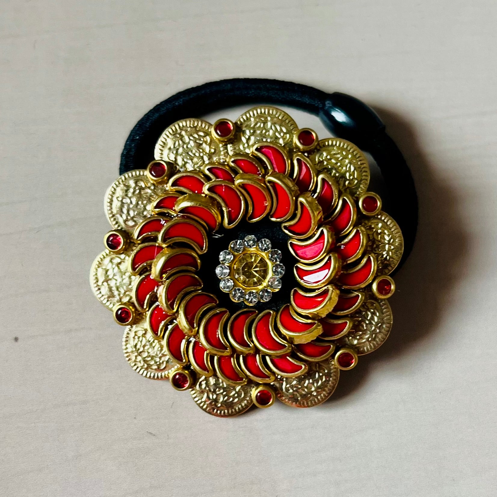 Surya Kalika hair accessory, juda pin, traditional hair accessory, bridal hair brooch, red gold hair clip, bun pin for saree, ethnic hair ornament, Indian hair accessory, juda hair brooch, wedding hair pin, kundan style hair pin, temple jewelry accessory, South Indian hair clip, festive hair accessory, handmade hair brooch, floral bun pin, juda accessory for women, ethnic hair clip, hair accessory for lehenga, designer juda pin