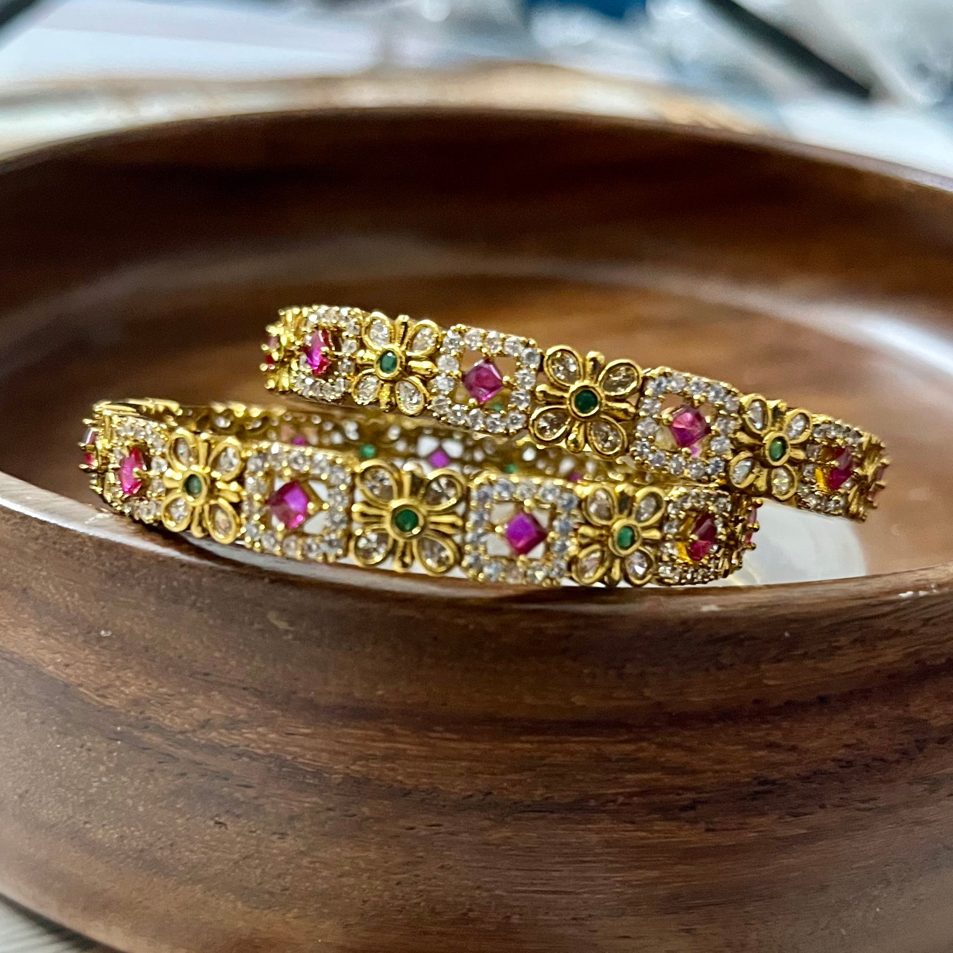 floral bangles, gold tone bangles, ruby stone bangles, emerald bangles, traditional bangles, Indian bangles, designer bangles, festive jewelry, wedding bangles, bridal bangles, ethnic jewelry, imitation bangles, kundan style bangles, party wear bangles, temple jewelry, handmade bangles, statement bangles, pushpa valli bangles, Indian accessories, South Indian jewelry