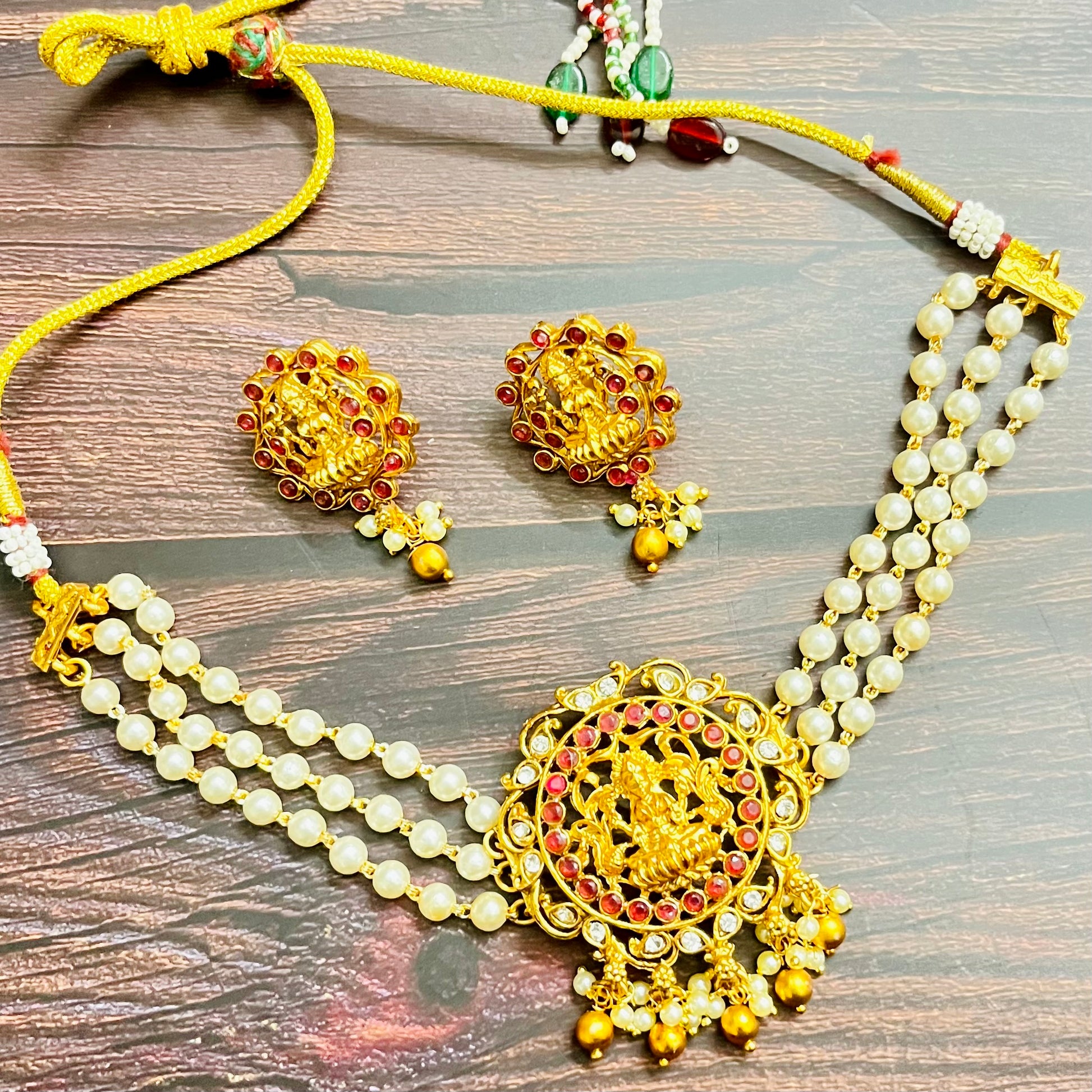 lakshmi choker, temple jewelry, pearl choker, traditional jewelry, Indian jewelry, south Indian style, bridal choker set, handcrafted jewelry, gold plated, festive wear, ethnic accessories, wedding jewelry, goddess jewelry, kundan stones, handmade necklace, antique finish, cultural jewelry, jewelry set with earrings, pooja jewelry, divine design, Indian bride, pearl necklace set, goddess lakshmi, matsya boutique, statement choker