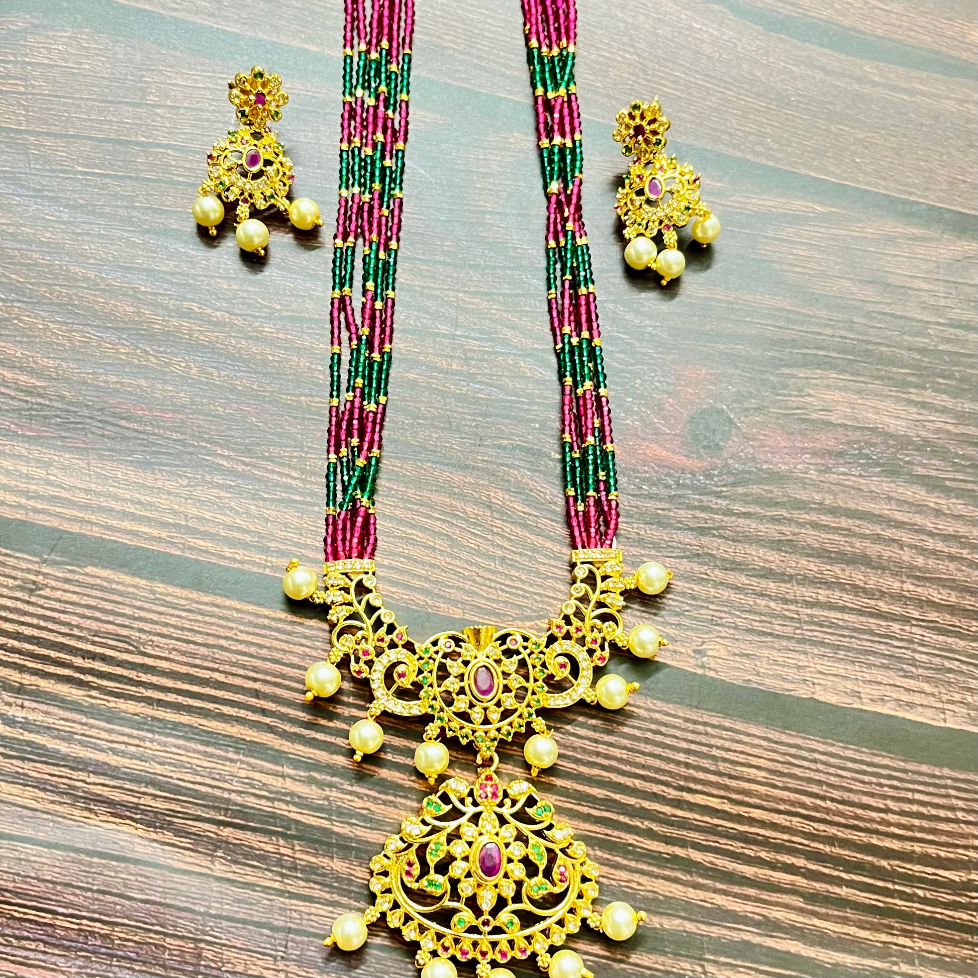 traditional necklace, temple jewelry, bridal jewelry, ethnic wear, gold finish, Indian necklace, pearl necklace, antique jewelry, wedding jewelry, designer jewelry, South Indian jewelry, festive look, handmade jewelry, ruby green beads, jewelry for saree, party wear jewelry, statement necklace, trending jewelry, jewelry set, ethnic necklace, earrings and necklace, kundan work, bridal set, beaded necklace, pearl drops