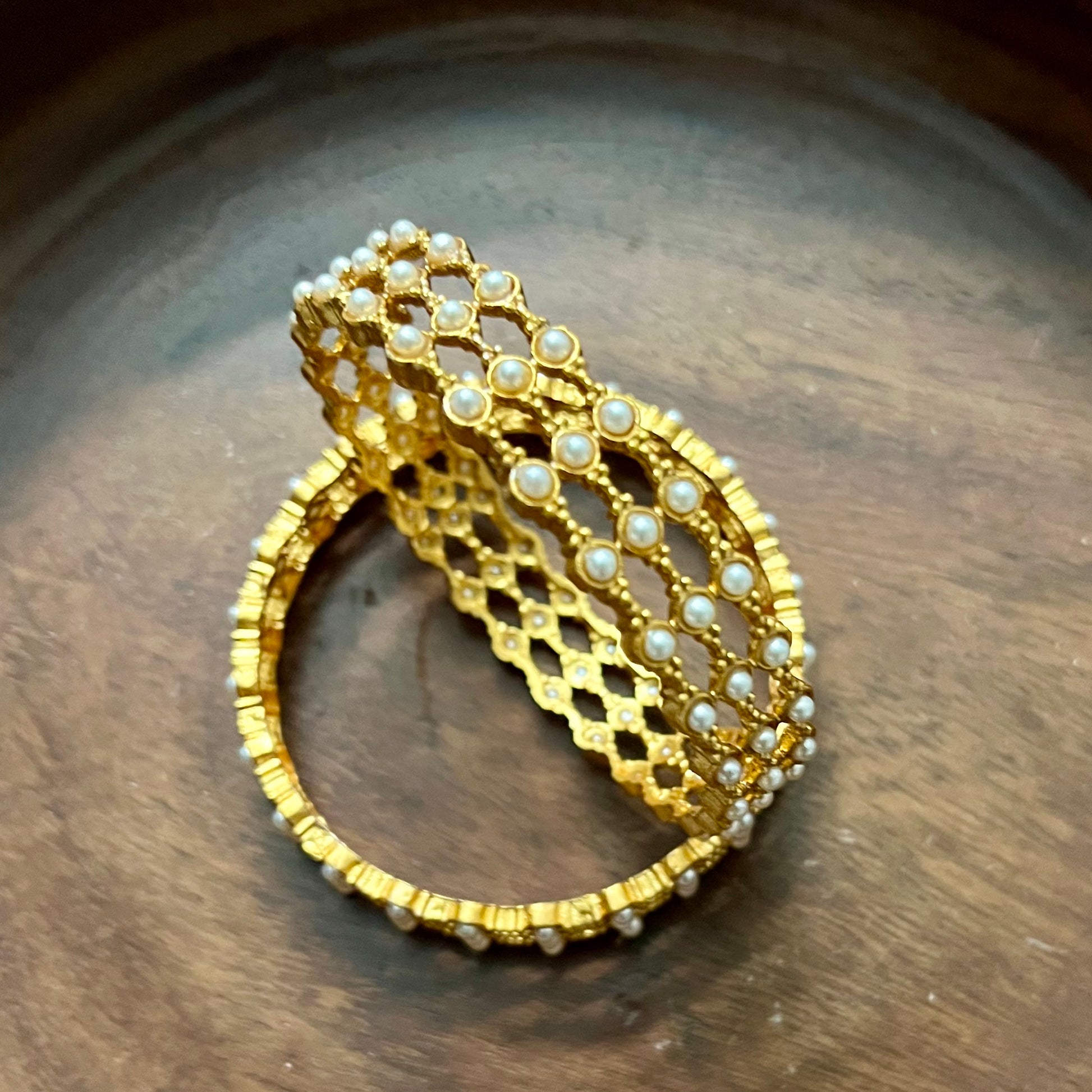 pearl mesh bangles, gold tone bangles, bridal bangles set, traditional kada bangles, pearl kada for women, ethnic bangle set, Indian wedding bangles, festive wear bangles, gold pearl kada, handcrafted bangles, royal pearl bangles, mesh design bangles, kundan style bangles, designer bangles online, party wear bangles for saree