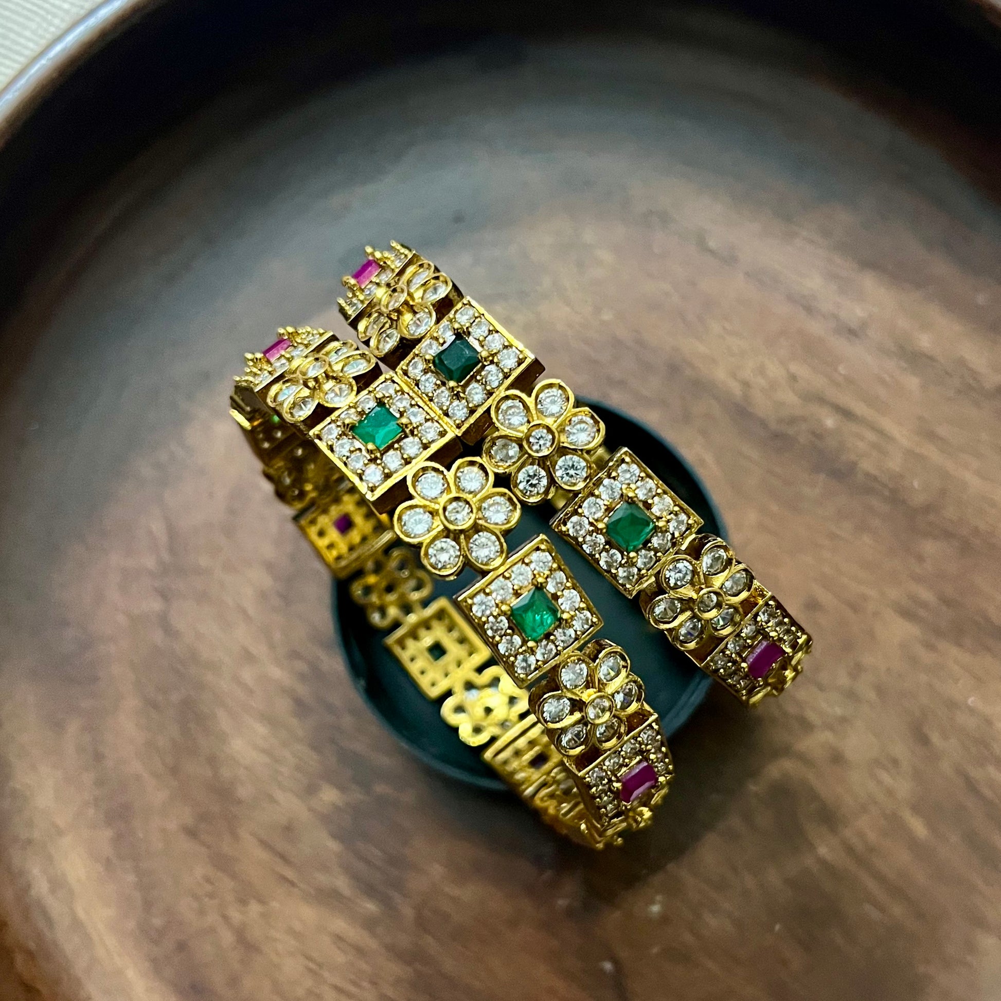 antique gold bangles, floral design bangles, emerald ruby bangles, kundan stone bangles, wedding bangle set, traditional kada bangles, bridal bangles online, festive wear jewelry, stone studded bangles, ethnic jewelry for women, handcrafted Indian bangles, designer bangles for saree, party wear bangles, temple style bangles, royal look bangles