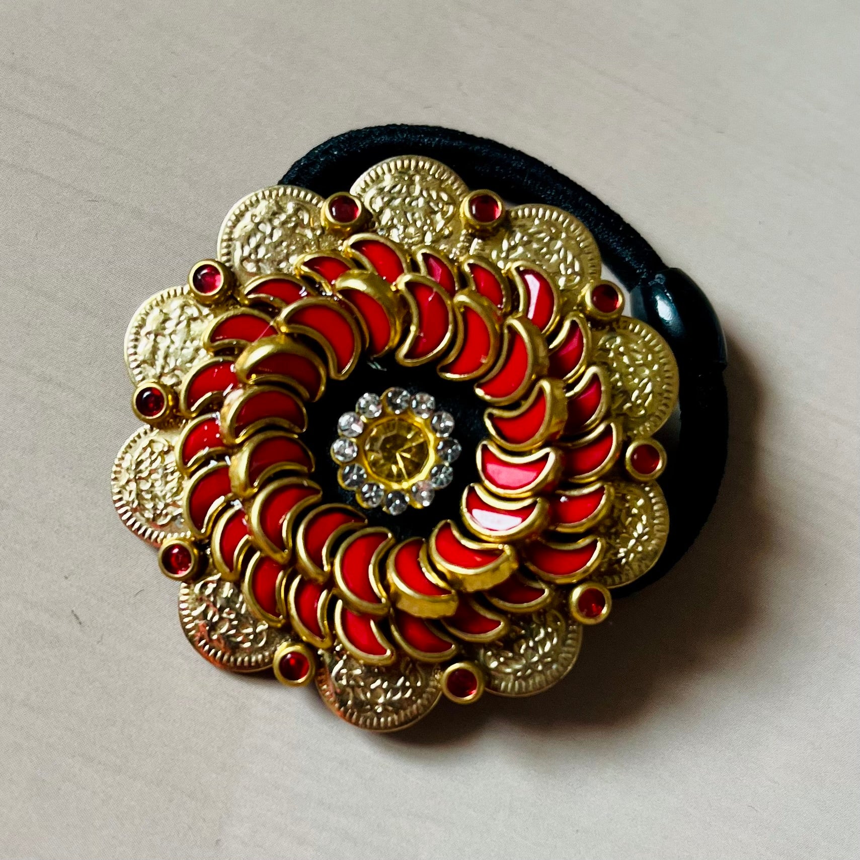 Surya Kalika hair accessory, juda pin, traditional hair accessory, bridal hair brooch, red gold hair clip, bun pin for saree, ethnic hair ornament, Indian hair accessory, juda hair brooch, wedding hair pin, kundan style hair pin, temple jewelry accessory, South Indian hair clip, festive hair accessory, handmade hair brooch, floral bun pin, juda accessory for women, ethnic hair clip, hair accessory for lehenga, designer juda pin