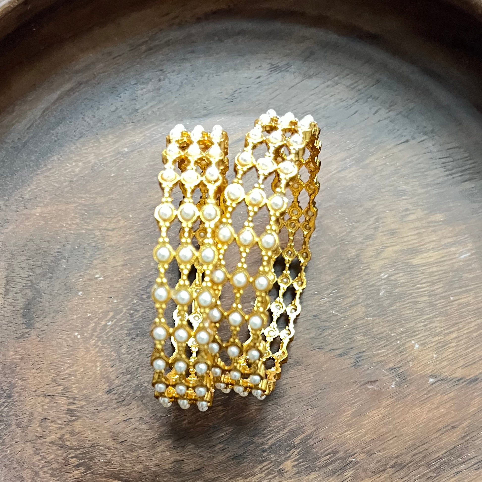 pearl mesh bangles, gold tone bangles, bridal bangles set, traditional kada bangles, pearl kada for women, ethnic bangle set, Indian wedding bangles, festive wear bangles, gold pearl kada, handcrafted bangles, royal pearl bangles, mesh design bangles, kundan style bangles, designer bangles online, party wear bangles for saree