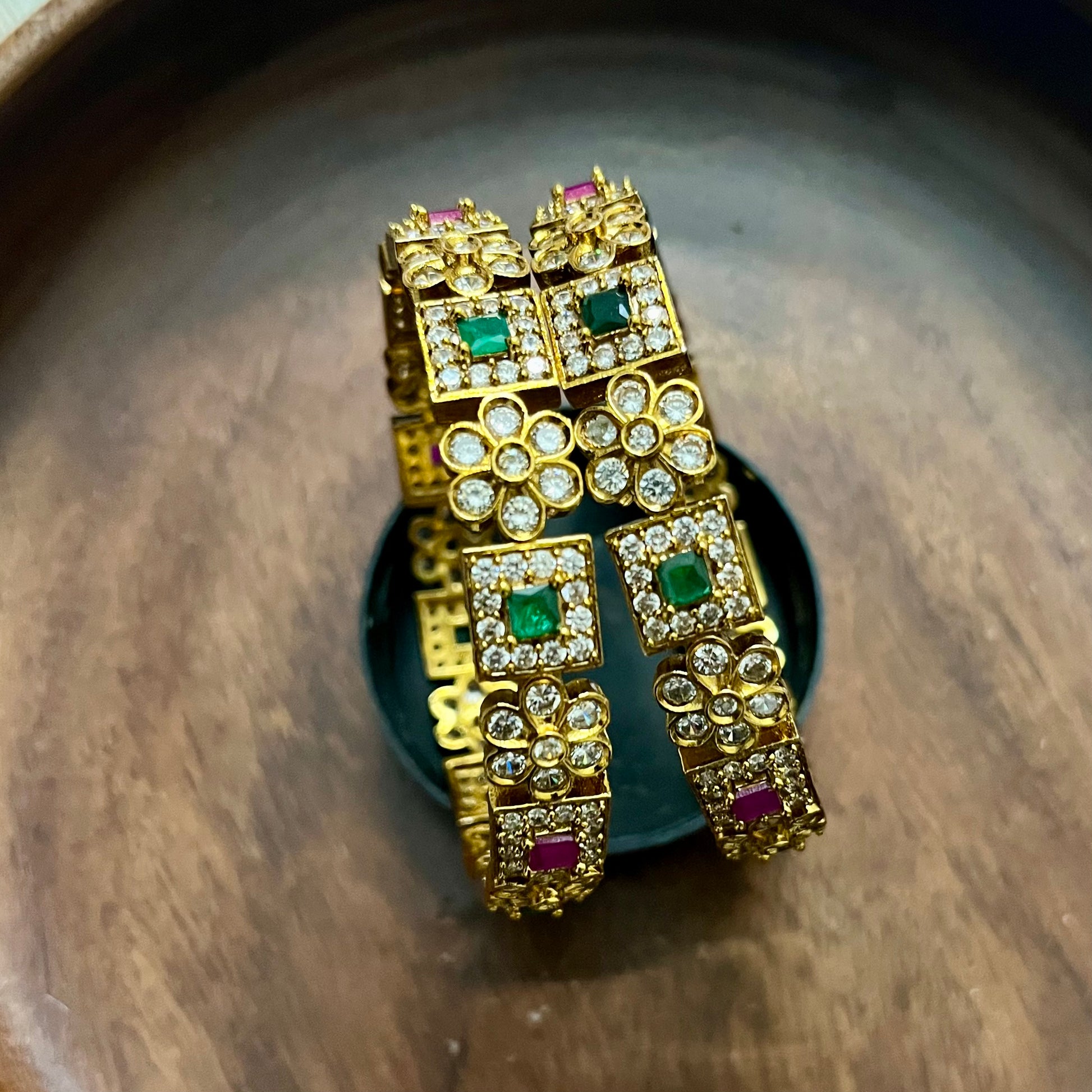 antique gold bangles, floral design bangles, emerald ruby bangles, kundan stone bangles, wedding bangle set, traditional kada bangles, bridal bangles online, festive wear jewelry, stone studded bangles, ethnic jewelry for women, handcrafted Indian bangles, designer bangles for saree, party wear bangles, temple style bangles, royal look bangles