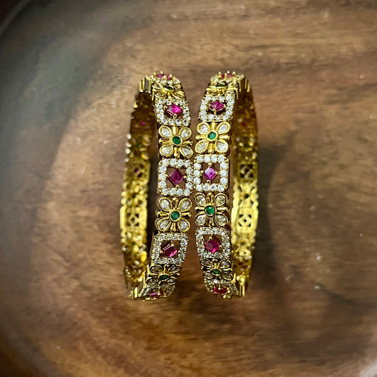 floral bangles, gold tone bangles, ruby stone bangles, emerald bangles, traditional bangles, Indian bangles, designer bangles, festive jewelry, wedding bangles, bridal bangles, ethnic jewelry, imitation bangles, kundan style bangles, party wear bangles, temple jewelry, handmade bangles, statement bangles, pushpa valli bangles, Indian accessories, South Indian jewelry