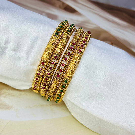 designer imitation bangles, red and green stone bangles, traditional jewelry, ethnic bangles, handmade bangles, Indian jewelry, imitation bangles online, festive accessories, handcrafted jewelry, stylish bangles, wedding jewelry, ethnic wear accessories, Matsya Boutique bangles, jewelry for women, designer jewelry