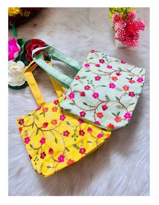 "Charming floral mini bags featuring vibrant flower designs, perfect for holding small essentials or as delightful return gifts for festive and special occasions."