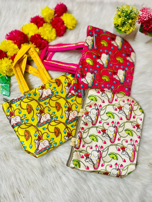 "Pichwai-themed tamboolam bags featuring traditional Indian artwork, adorned with vibrant Pichwai cow and floral motifs, perfect for gifting during festive occasions."