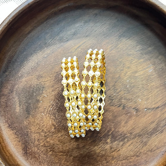 pearl mesh bangles, gold tone bangles, bridal bangles set, traditional kada bangles, pearl kada for women, ethnic bangle set, Indian wedding bangles, festive wear bangles, gold pearl kada, handcrafted bangles, royal pearl bangles, mesh design bangles, kundan style bangles, designer bangles online, party wear bangles for saree