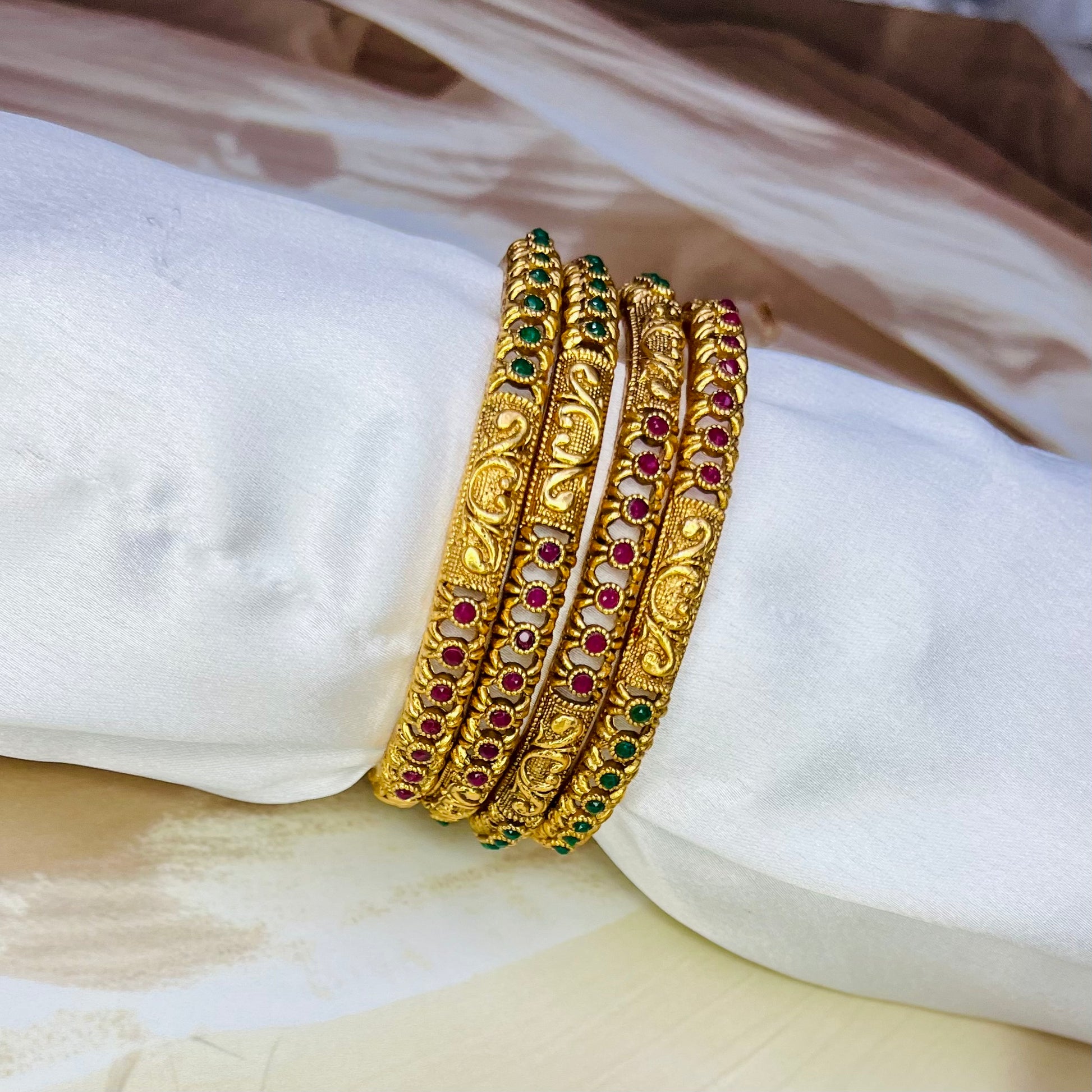 designer imitation bangles, red and green stone bangles, traditional jewelry, ethnic bangles, handmade bangles, Indian jewelry, imitation bangles online, festive accessories, handcrafted jewelry, stylish bangles, wedding jewelry, ethnic wear accessories, Matsya Boutique bangles, jewelry for women, designer jewelry