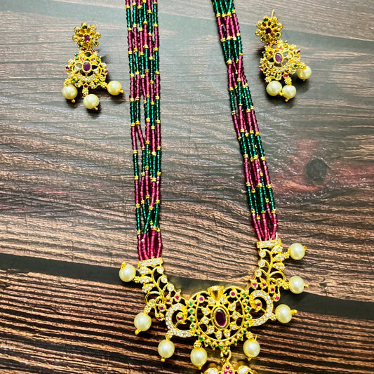 traditional necklace, temple jewelry, bridal jewelry, ethnic wear, gold finish, Indian necklace, pearl necklace, antique jewelry, wedding jewelry, designer jewelry, South Indian jewelry, festive look, handmade jewelry, ruby green beads, jewelry for saree, party wear jewelry, statement necklace, trending jewelry, jewelry set, ethnic necklace, earrings and necklace, kundan work, bridal set, beaded necklace, pearl drops