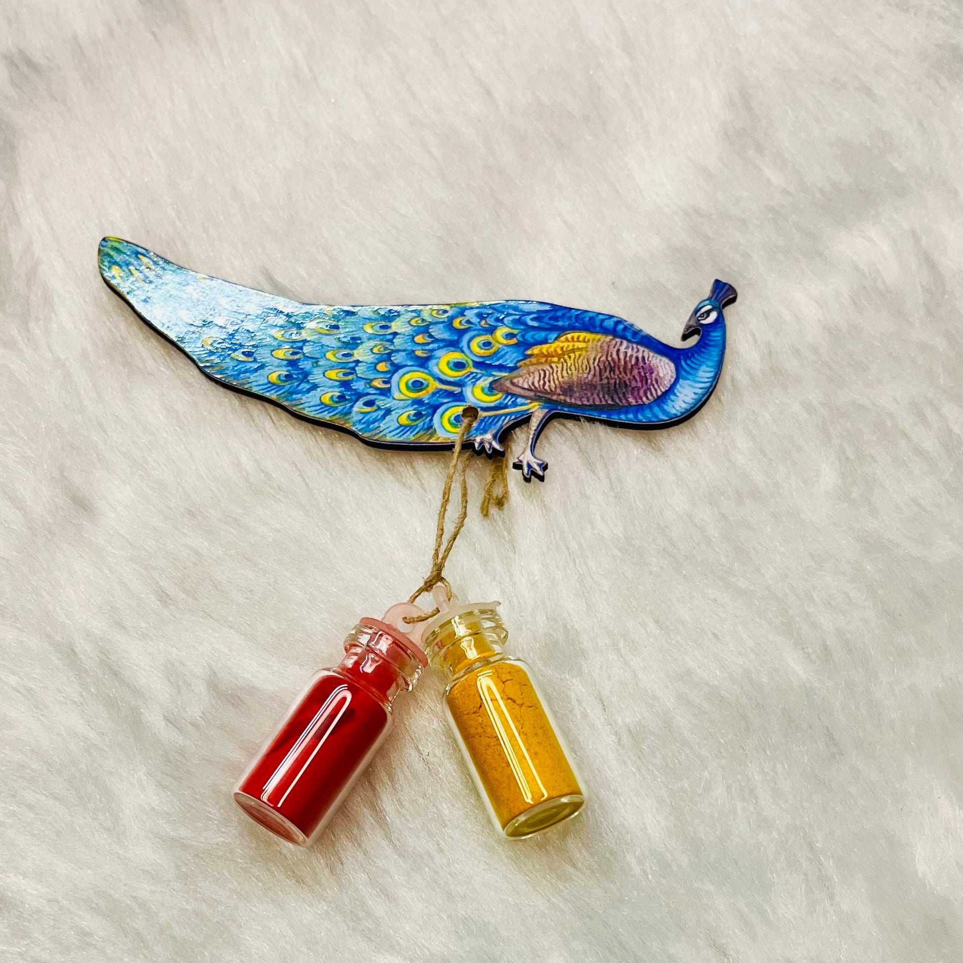 Vibrant Pichwai-style peacock Haldi Kumkum holder, depicting a detailed blue and green peacock with two glass bottles of turmeric (haldi) and vermillion (kumkum), ideal for traditional Indian rituals and ceremonies.

Pichwai peacock Haldi Kumkum holder, Indian Haldi Kumkum decor, traditional Indian ceremony accessory, colorful Pichwai art, Hindu ritual essentials.