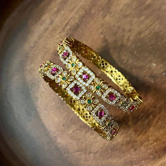 floral bangles, gold tone bangles, ruby stone bangles, emerald bangles, traditional bangles, Indian bangles, designer bangles, festive jewelry, wedding bangles, bridal bangles, ethnic jewelry, imitation bangles, kundan style bangles, party wear bangles, temple jewelry, handmade bangles, statement bangles, pushpa valli bangles, Indian accessories, South Indian jewelry