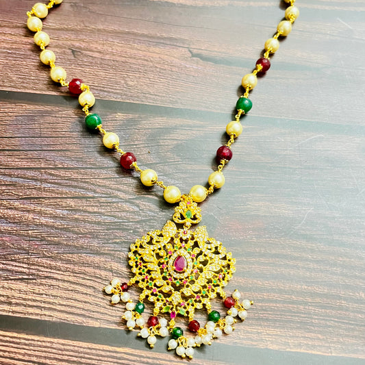 traditional necklace, temple jewelry, Indian bridal jewelry, handmade necklace, festive jewelry, gold-plated pendant, statement jewelry, pearl necklace, ruby green necklace, ethnic jewelry, South Indian jewelry, kundan choker, designer necklace, party wear jewelry, bridal set, imitation jewelry, boutique collection, ethnic wear look, wedding collection, elegant Indian necklace