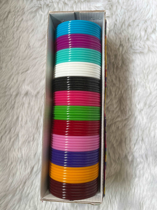 Colorful plastic bangles used as the base for making handmade silk thread bangles